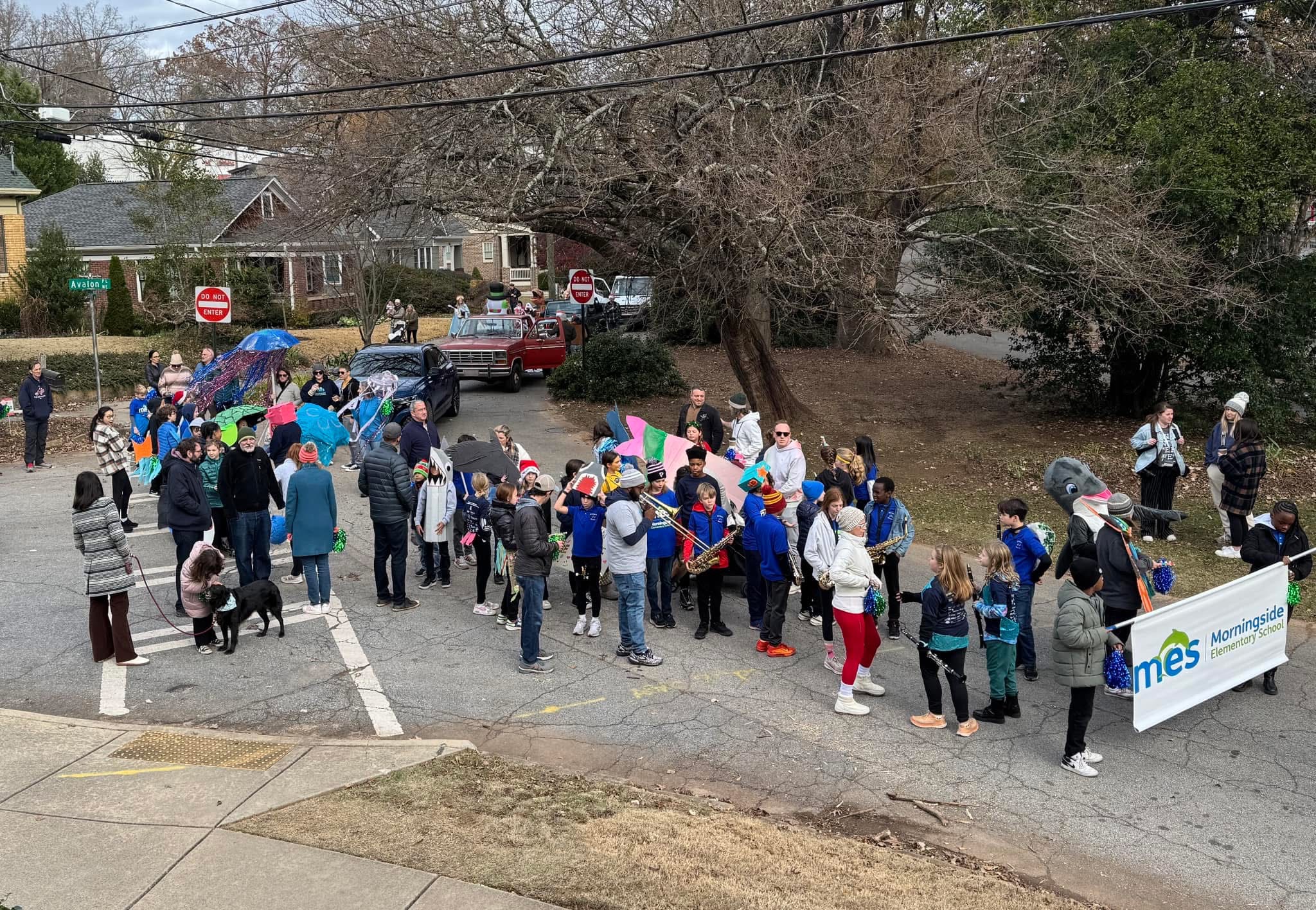 A group of people standing on a streetDescription automatically generated